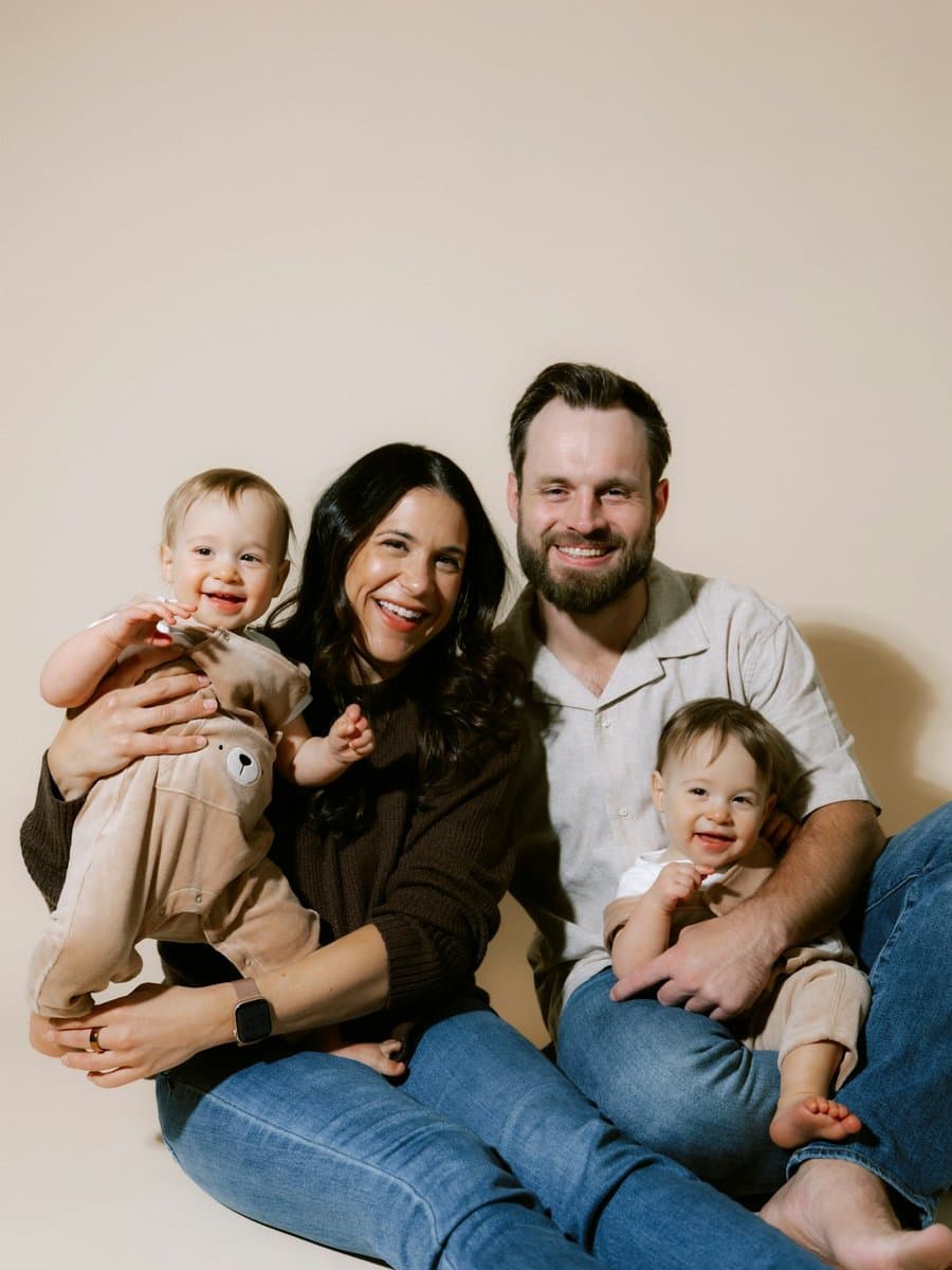 A smiling mum and dad with their two young children